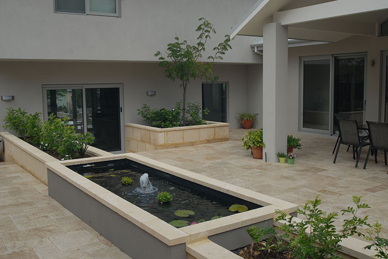 Courtyard garden with water feature and stone paving